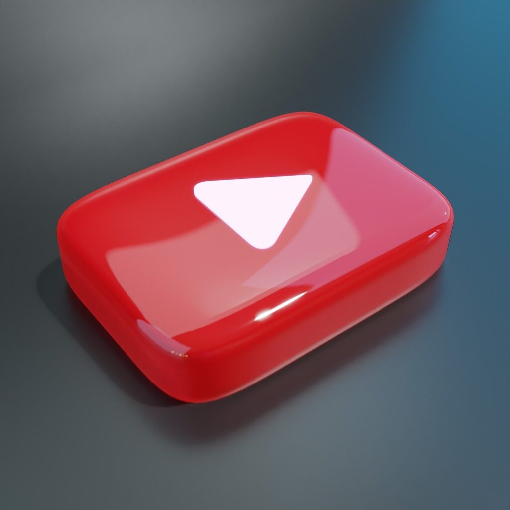 3D glossy red YouTube play button icon on a dark gradient background.